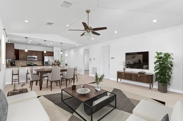 living room featuring sink, ceiling fan, lofted ceiling, and light tile patterned flooring