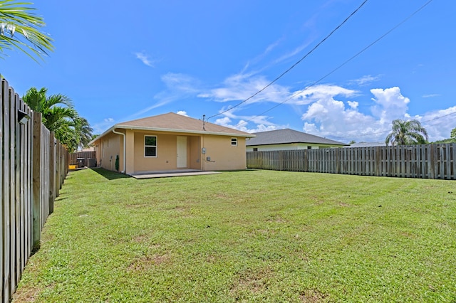 back of property featuring a yard and a patio area