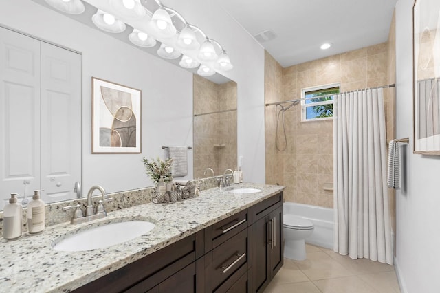 full bathroom featuring tile patterned flooring, vanity, toilet, and shower / bath combo with shower curtain