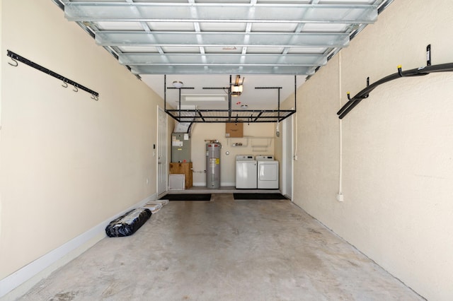 garage featuring washing machine and dryer and electric water heater