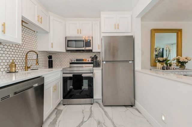 kitchen featuring sink, stainless steel appliances, white cabinets, and decorative backsplash