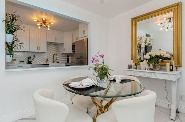 dining room featuring an inviting chandelier and sink