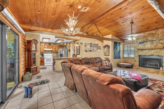 tiled living room with ceiling fan with notable chandelier, lofted ceiling with beams, wooden ceiling, and a stone fireplace