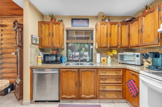 kitchen featuring dishwasher, decorative backsplash, light tile patterned flooring, and sink