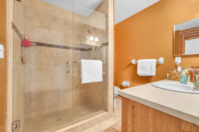 bathroom featuring vanity, toilet, walk in shower, and tile patterned flooring