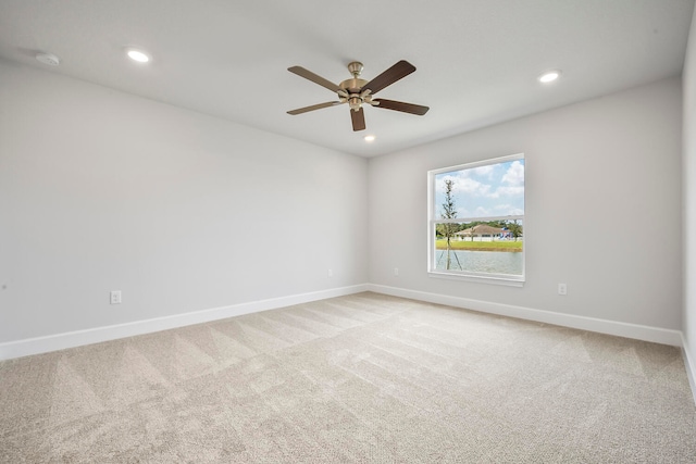 unfurnished room featuring ceiling fan and light colored carpet