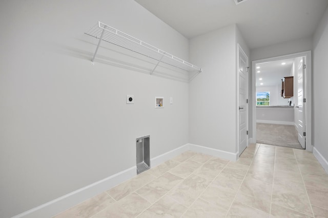 clothes washing area with electric dryer hookup, hookup for a washing machine, and light tile patterned floors