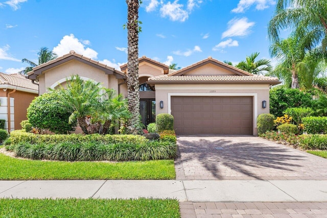 mediterranean / spanish home with a garage