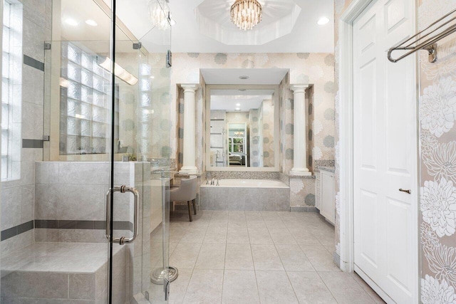 bathroom with vanity, shower with separate bathtub, a notable chandelier, decorative columns, and tile patterned floors