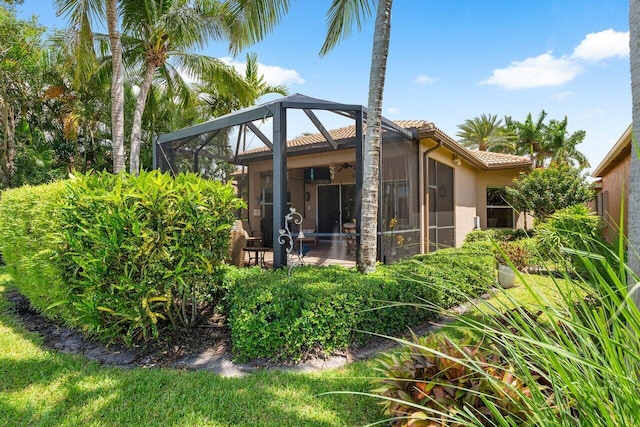 back of house with a lanai and a patio area