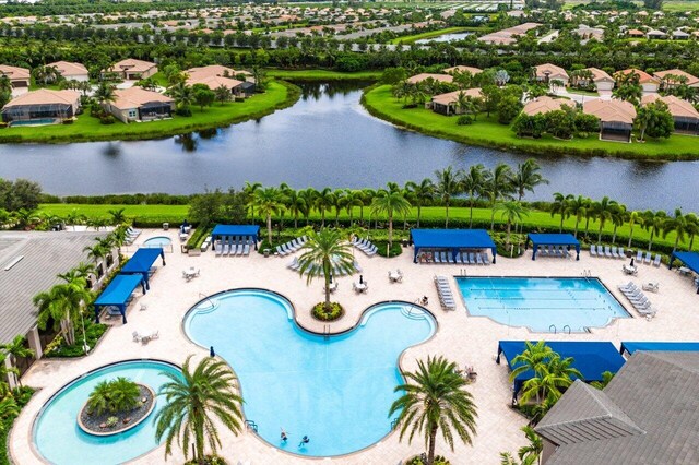 view of pool with a water view and a patio area