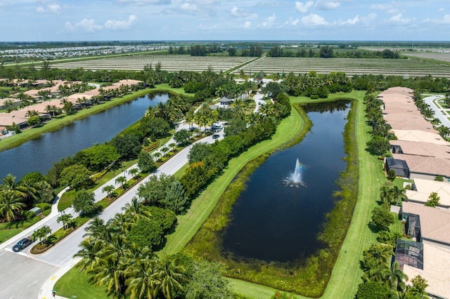 birds eye view of property featuring a water view and a rural view