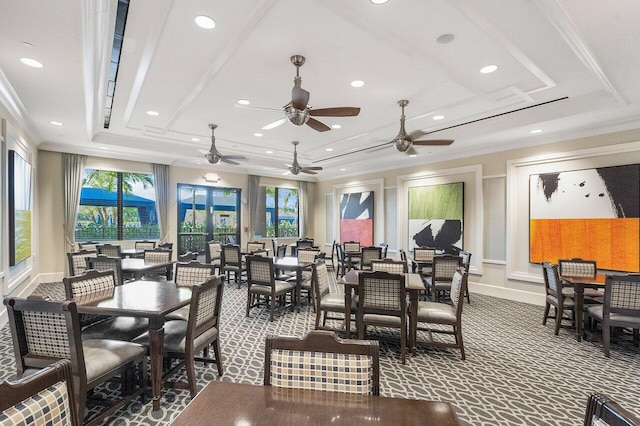 interior space with carpet flooring, ceiling fan, ornamental molding, and a raised ceiling