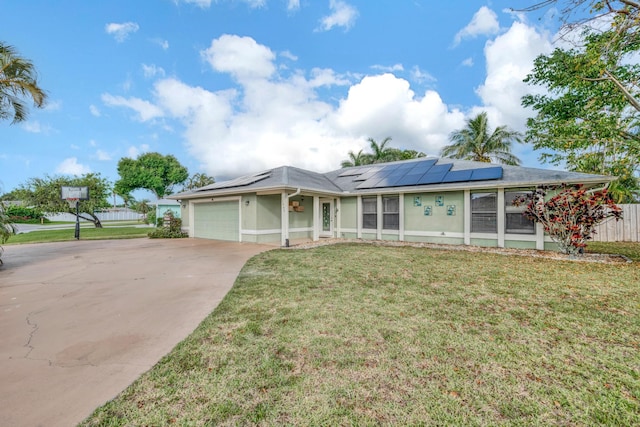 single story home with a garage, a front yard, and solar panels