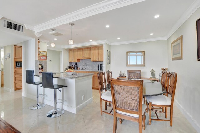 tiled dining space with ornamental molding