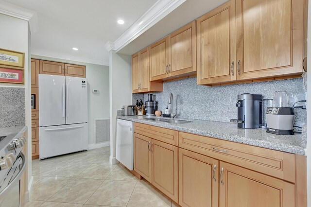 kitchen with white appliances, tasteful backsplash, ornamental molding, sink, and light stone counters