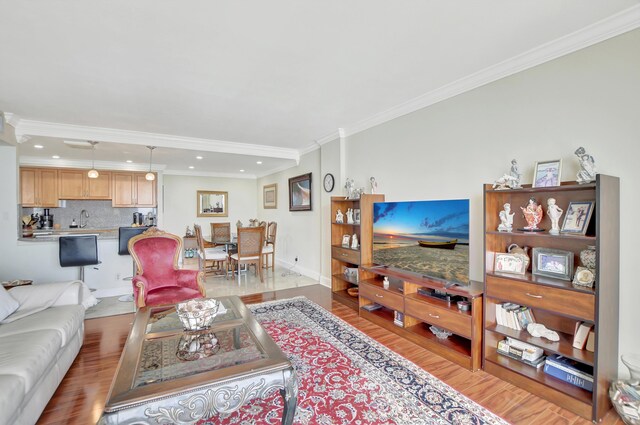 living room with crown molding and light wood-type flooring