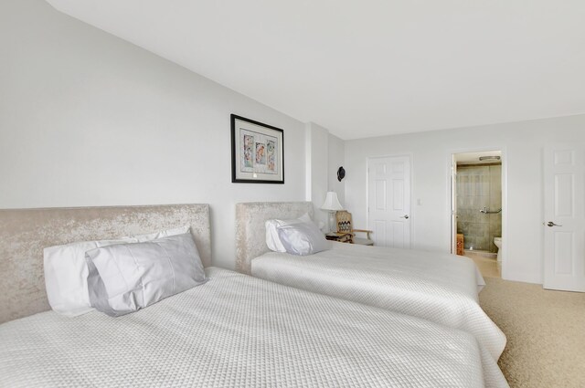 carpeted bedroom featuring ensuite bath