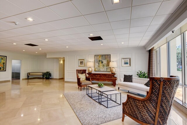 living room with plenty of natural light and a drop ceiling