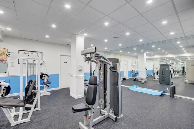 exercise room with a paneled ceiling