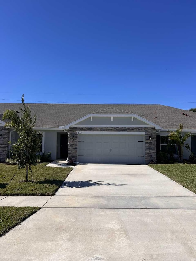 ranch-style house with a front lawn and a garage