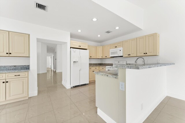 kitchen featuring kitchen peninsula, sink, light stone countertops, and white appliances