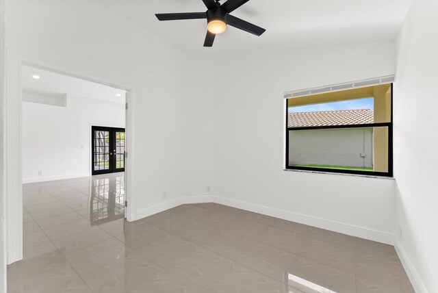 unfurnished room with french doors, ceiling fan, vaulted ceiling, and a healthy amount of sunlight