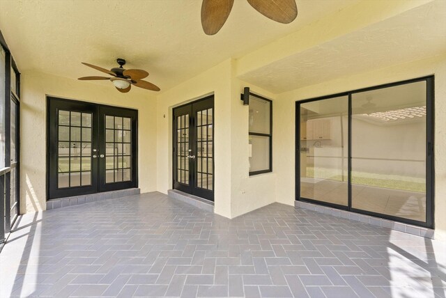 unfurnished sunroom with french doors and ceiling fan