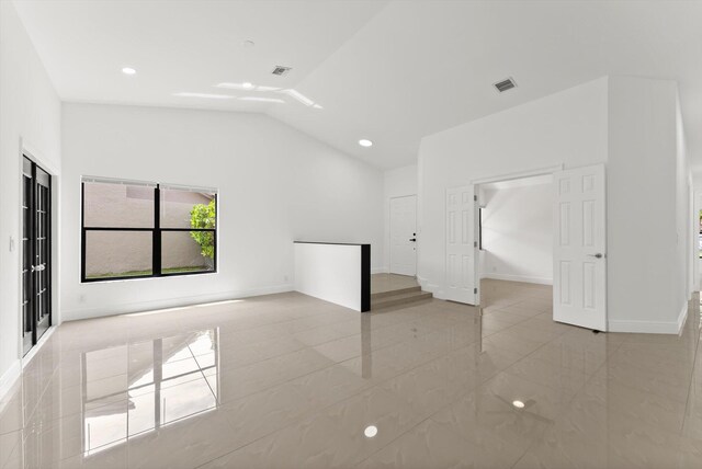 unfurnished room featuring vaulted ceiling