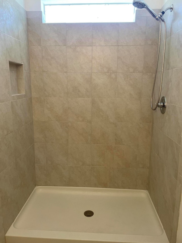 bathroom with tiled shower