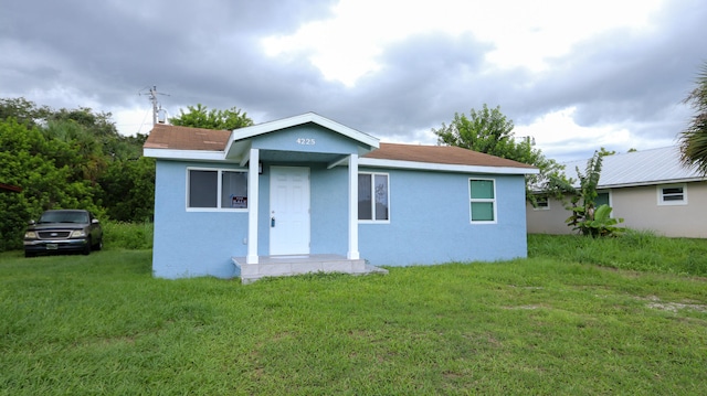 rear view of house with a lawn