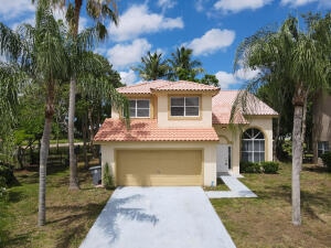 mediterranean / spanish-style home with a garage