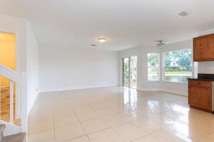 unfurnished living room with light tile patterned flooring