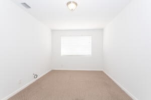 unfurnished room featuring light colored carpet