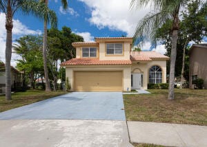 mediterranean / spanish-style home with a garage