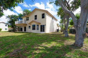 back of house with a lawn