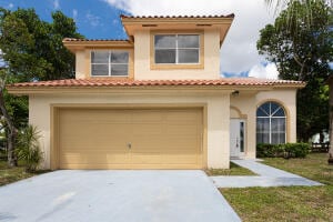 mediterranean / spanish home with a garage