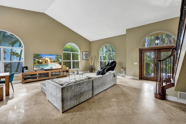 living room featuring high vaulted ceiling