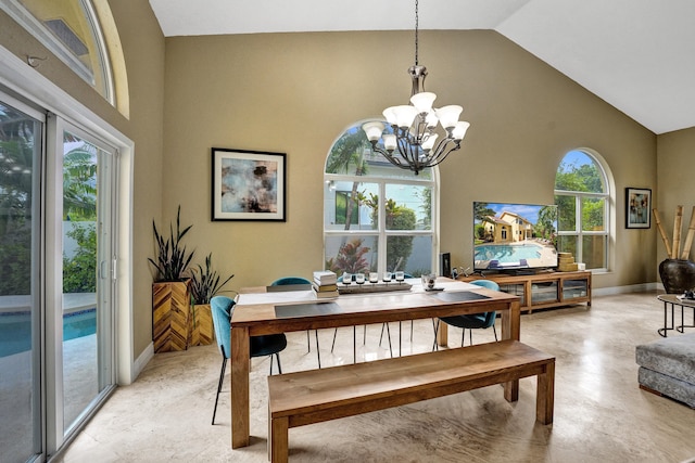 dining area featuring high vaulted ceiling and a notable chandelier