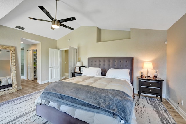 bedroom featuring light wood-type flooring, lofted ceiling, and ceiling fan