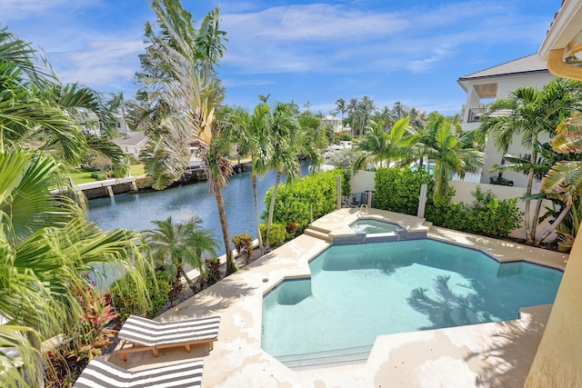 view of swimming pool featuring an in ground hot tub and a water view