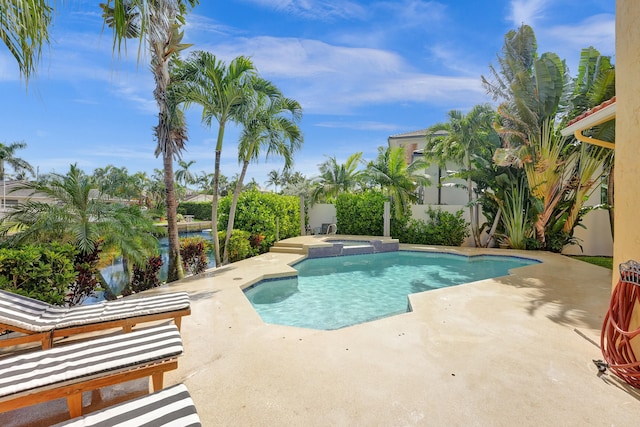 view of pool with an in ground hot tub and a patio area