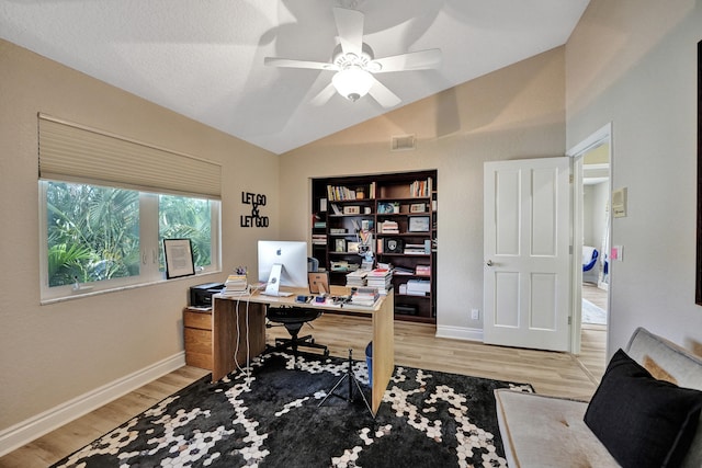 office space featuring vaulted ceiling, light hardwood / wood-style flooring, and ceiling fan