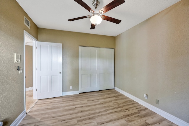 unfurnished bedroom with a closet, ceiling fan, and light hardwood / wood-style floors