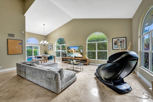 living room featuring high vaulted ceiling, plenty of natural light, and an inviting chandelier