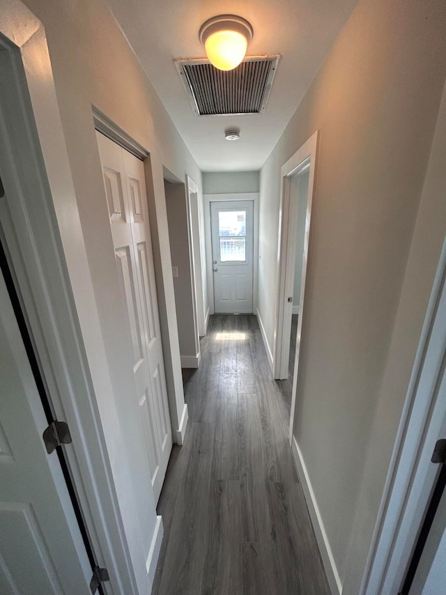 hallway with dark wood-type flooring