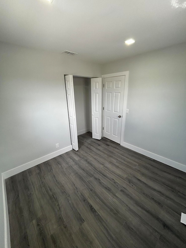 unfurnished bedroom featuring dark wood-type flooring