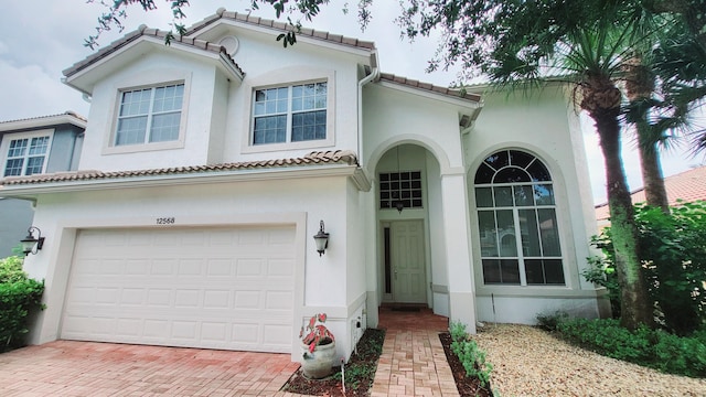 mediterranean / spanish-style house with a garage