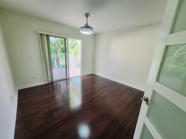 spare room featuring dark wood-type flooring