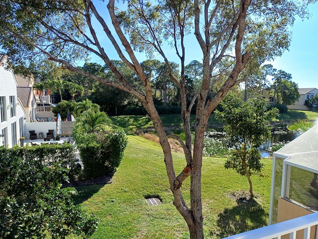 view of yard featuring a water view and a patio area